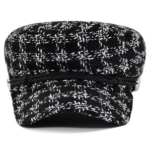 Classic black and white tweed newsboy cap with decorative rope and silver buttons