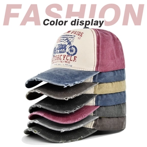 Vertical display of stacked vintage washed baseball caps with motorcycle graffiti print