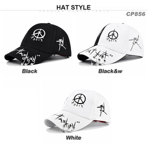 Detail of graffiti embroidery and metallic rings on the brim of the cotton baseball cap