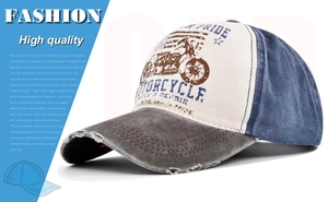 Detail of distressed brim and retro motorcycle graffiti print on a vintage baseball cap