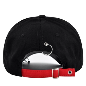 Black graffiti baseball cap with red back strap and metal ring seen from the rear view