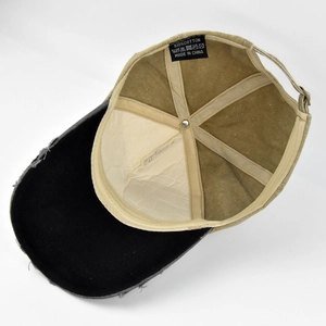 Inside view showing 100% cotton label and distressed brim detail of the baseball cap