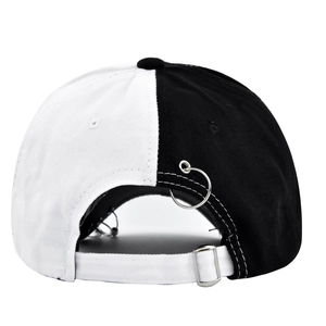 Detail of baseball cap back with black and white split design and metal ring accents