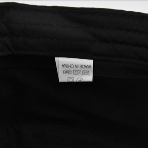 Close-up of the internal care label on a black flat cap showing washing instructions