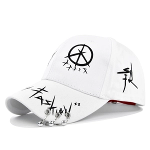 Close-up of white graffiti baseball cap with silver metal rings and black fashion print