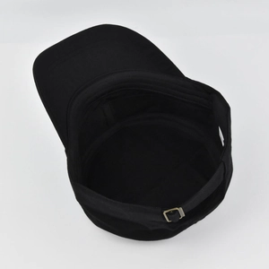 Detail of black cadet hat interior featuring cotton sweatband and bronze metal buckle