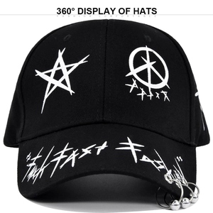 Detail of black baseball cap with white graffiti stars and silver metal ring charms