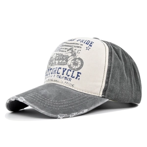 Detail of vintage washed denim baseball cap with distressed brim and motorcycle print