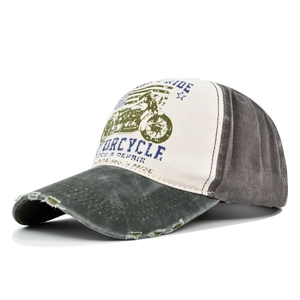Detail view of washed distressed baseball cap with motorcycle graffiti and worn holes