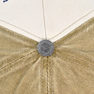 Macro view of cotton twill baseball cap crown with contrast stitching and top button