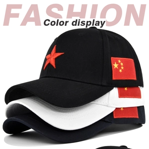 Detailed close-up showing embroidered red star and national flag on baseball caps