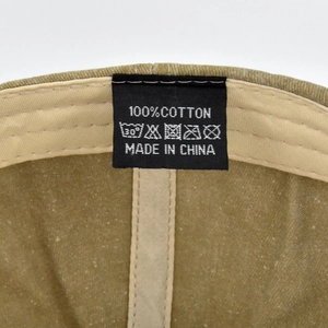 Detail view of the 100% cotton wash label and interior stitching of the baseball cap