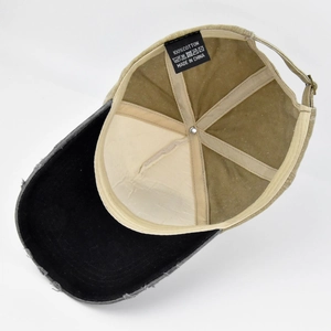 Detail view of cotton inner lining and washing label on distressed patchwork baseball cap
