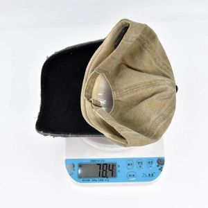 Close-up of a vintage patchwork baseball cap on a digital scale weighing 78.4g