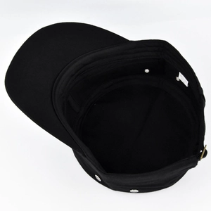 Detailed view of the internal sweatband and breathable metal eyelets on a black cadet cap