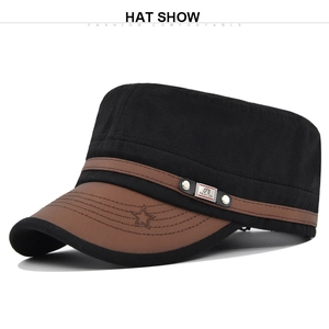 Close-up of black canvas cadet cap with brown leather brim and embroidered star