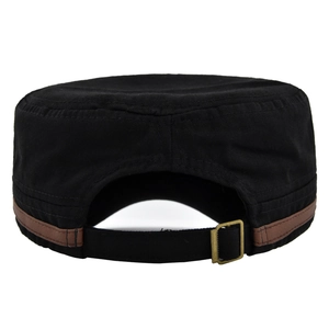 Detail of adjustable metal buckle and brown leather trim on a black cotton military cap