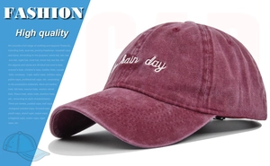 Detail of high-quality embroidered hair day text on washed burgundy baseball cap