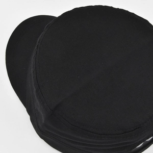 Close-up of the smooth flat top and cotton twill texture on a black cadet army hat