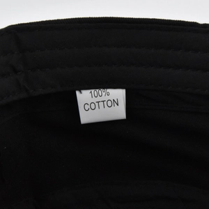 Detail view of 100% cotton material tag and quality stitching on the black military cap