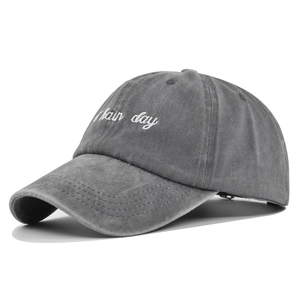 Close-up of 3D embroidery detail and washed cotton texture on a vintage baseball cap