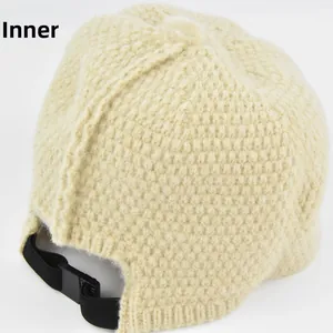 Detail view of the warm cream knit hat lining with adjustable elastic inner strap