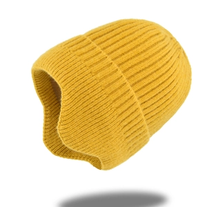 Detailed close-up of thick rib-knit texture on a ginger yellow winter beanie hat