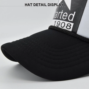 Close-up of black and white trucker hat featuring a star print and decorative rope