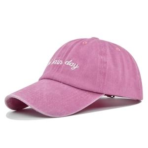 Detail of rose pink washed cotton baseball cap with white plain day embroidery
