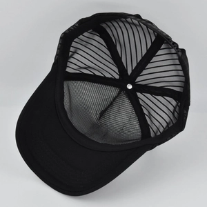 Internal view of black mesh trucker hat showing high-quality stitching and breathable design