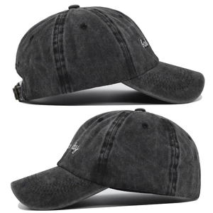 Detail of white bad day embroidery on vintage washed charcoal baseball cap fabric