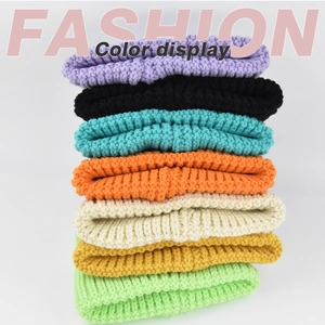 Close-up of thick knit texture and various candy-colored yarns of the winter hats