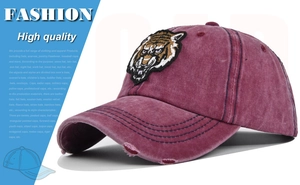 Close-up of vintage washed baseball cap with 3D tiger embroidery and distressed details
