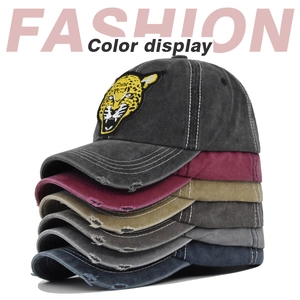 Close-up of vintage washed baseball caps with 3D leopard embroidery and distressed details