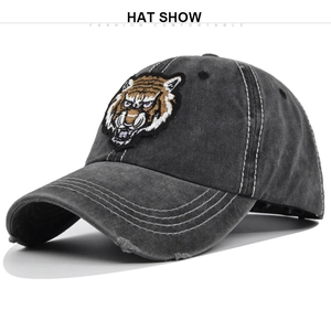 Detailed macro view of 3D tiger head embroidery on washed charcoal baseball cap