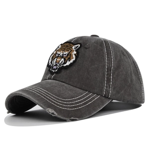 Detailed view of the vintage distressed baseball cap with tiger embroidery and worn edges
