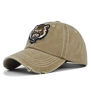 Detailed view of vintage washed baseball cap with 3D tiger embroidery and distressed brim