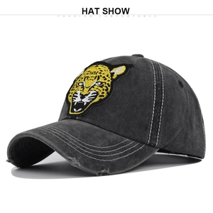 Detailed close-up of 3D leopard head embroidery on vintage washed denim baseball cap