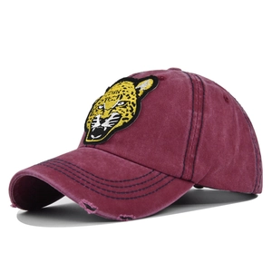 Detailed close-up of 3D leopard embroidery and distressed brim on vintage cotton cap