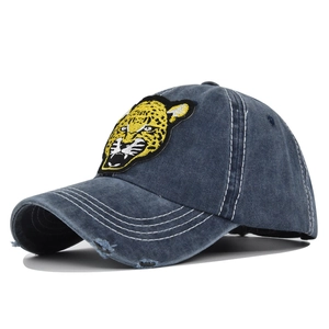 Vintage navy blue washed denim baseball cap with a bold leopard embroidery patch