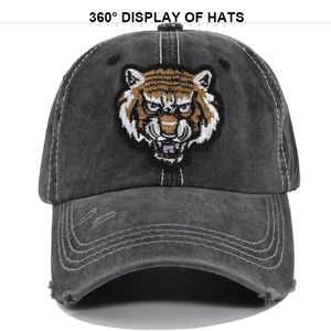 Detailed macro view of 3D tiger embroidery on washed grey distressed baseball cap