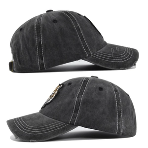 Detail of grey washed denim baseball cap with 3D tiger embroidery and worn edges