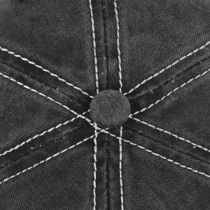 Macro detail of charcoal grey baseball cap top with contrast white double stitching