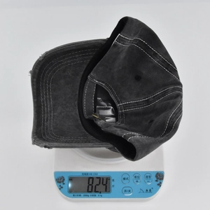 Detail shot of vintage washed grey baseball cap showing 82.4g weight on scale