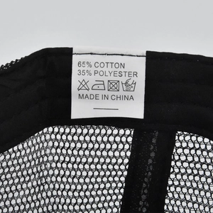 Detail shot of the 65% cotton care label and internal stitching on the black mesh baseball cap