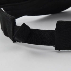 Close-up of adjustable Velcro strap on black sun hat showing stitching and fabric texture