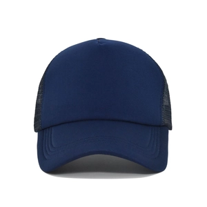 Detailed close-up of navy blue trucker hat featuring breathable mesh and curved brim