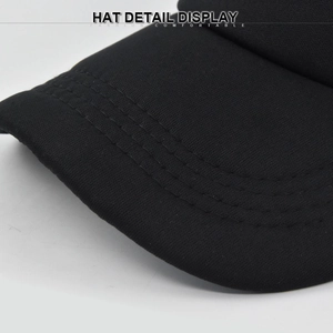Detail view of black baseball cap brim showing four rows of reinforced stitching