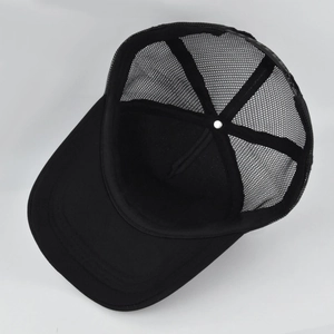 Internal view of the black trucker hat showing the breathable mesh and plastic snapback closure