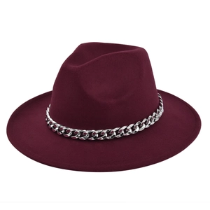Detail of silver metal chain on dark wine red wool fedora hat with flat brim design